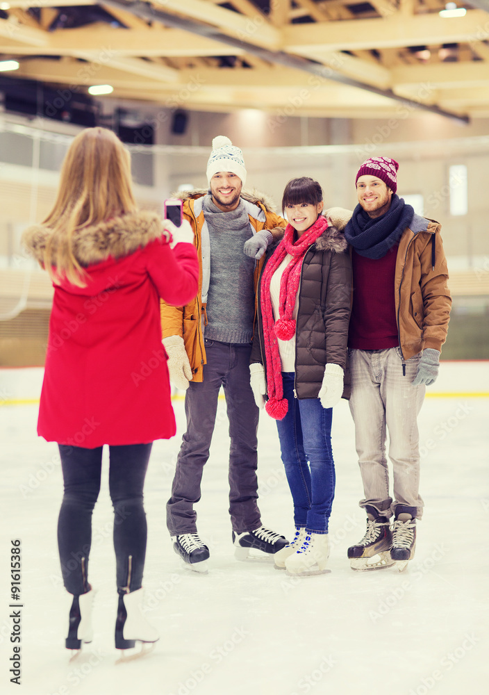 happy friends taking photo on skating rink happy friends taking photo on skating rink