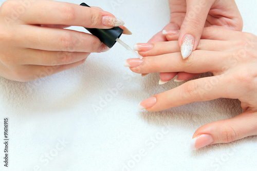 manicure making - female hands, covering of enamel