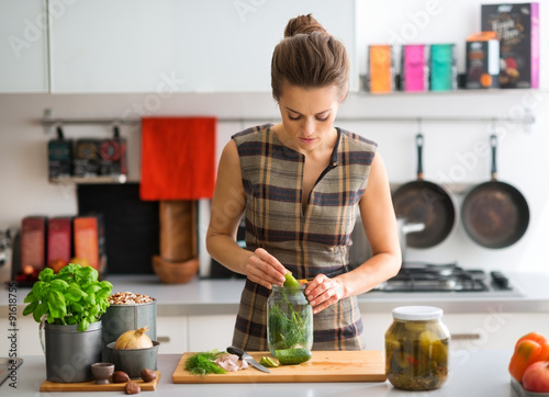 Photography Woman in kitchen preparing dill pickles