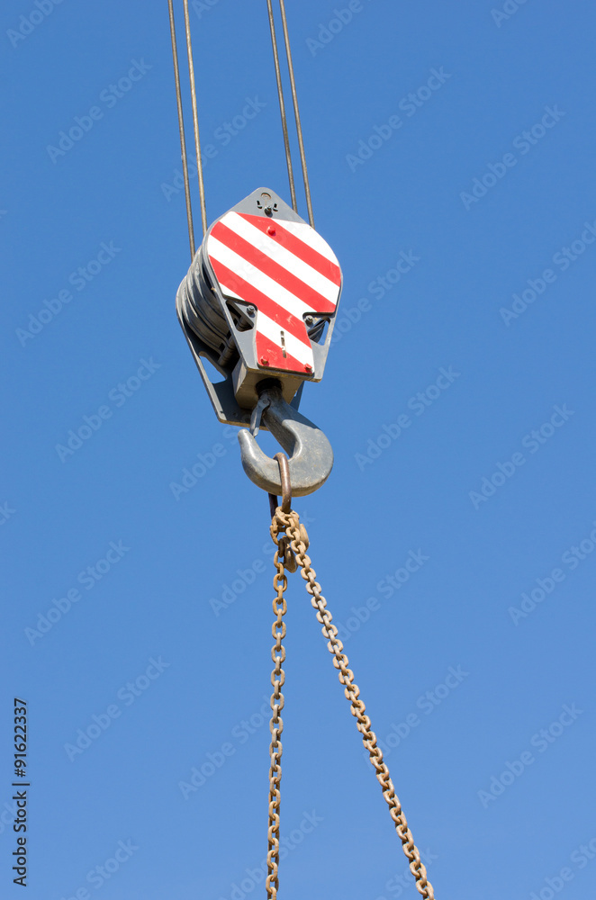 Crane hook against blue sky Crane hook against blue sky