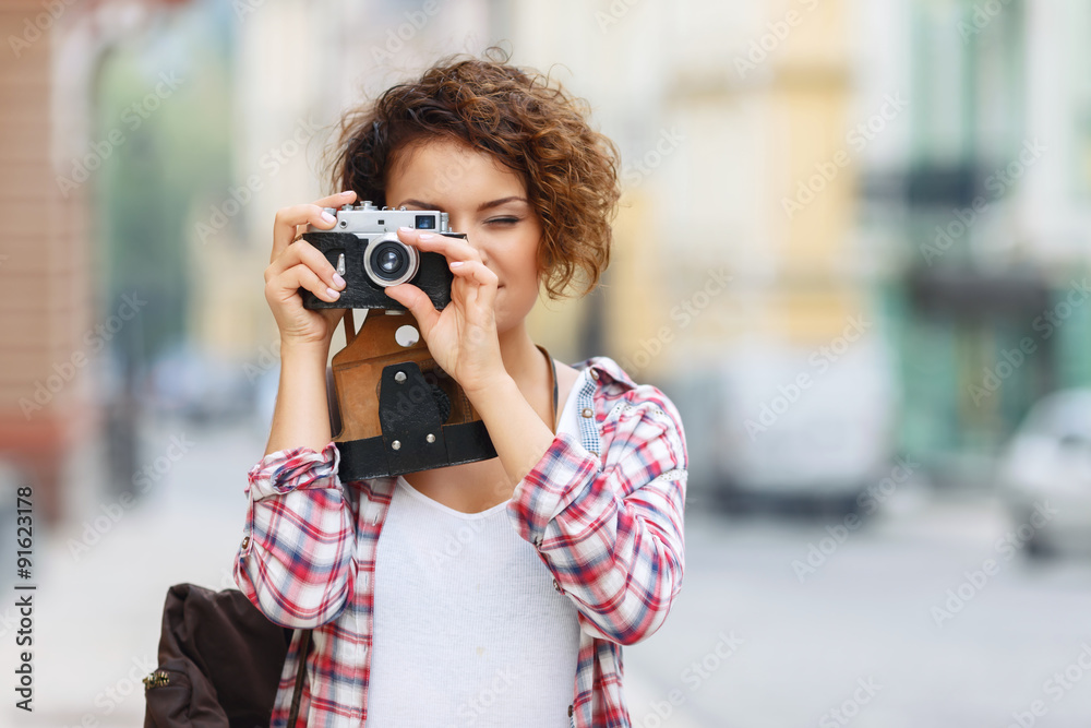 Smiling girl making photos 