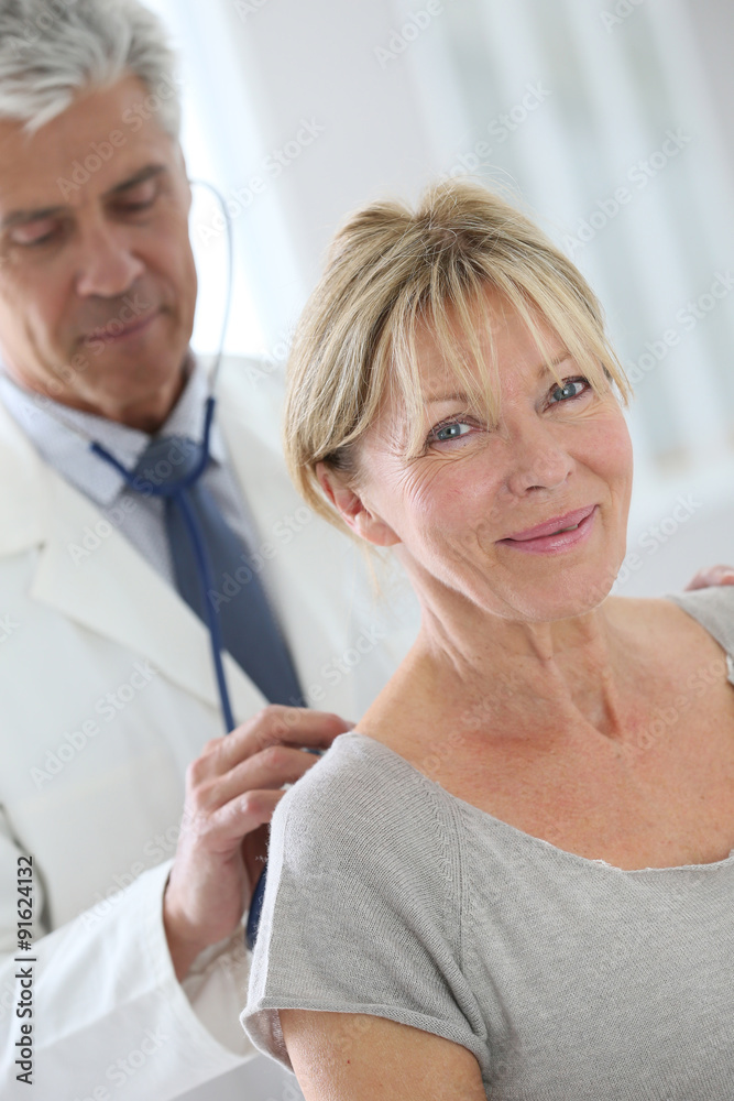Fototapeta premium Senior woman in doctor's room for consultation