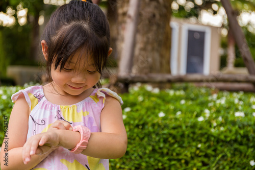 Little Girl Using Smartwatch or Smart Watch / Young Girl with Smartwatch or Smart Watch