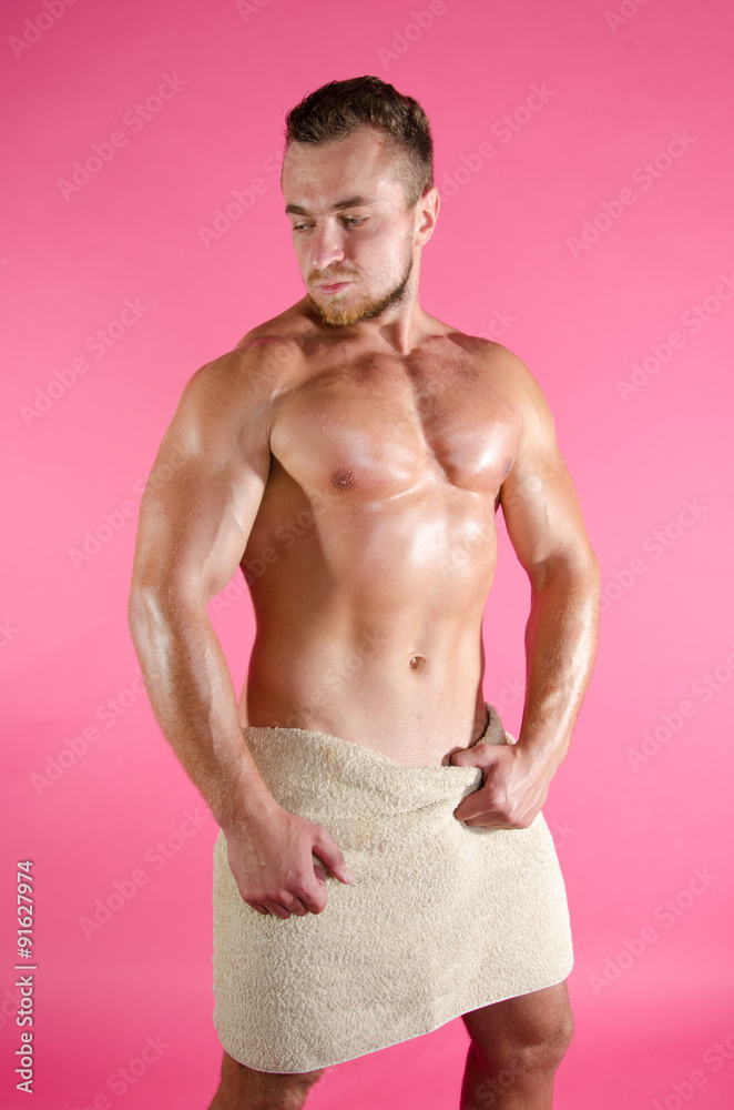 Fototapeta premium Wet Muscular Man Wrapped in Towel