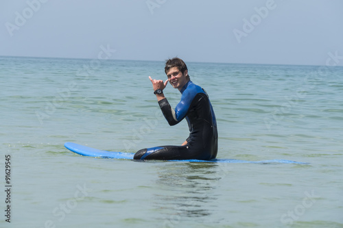 Photography Young boy surfing in the sea