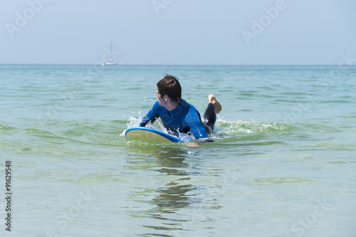 Photography Young boy surfing in the sea