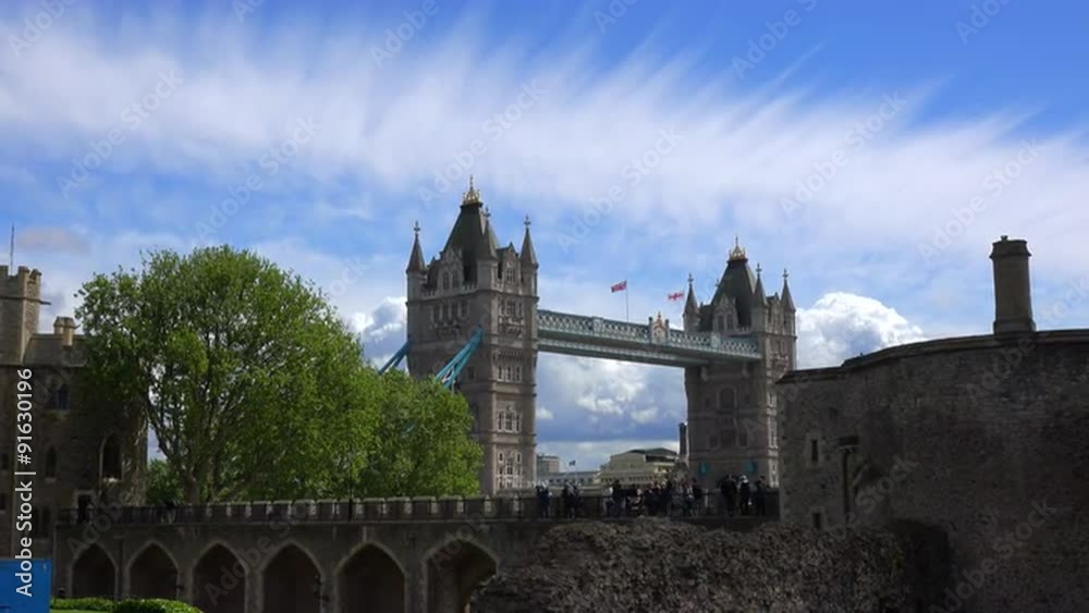 The Tower Bridge in London England is seen from the perspective of the Tower Of London with beautiful clouds background. The Tower Bridge in London England is seen from the perspective of the Tower Of London with beautiful clouds background.