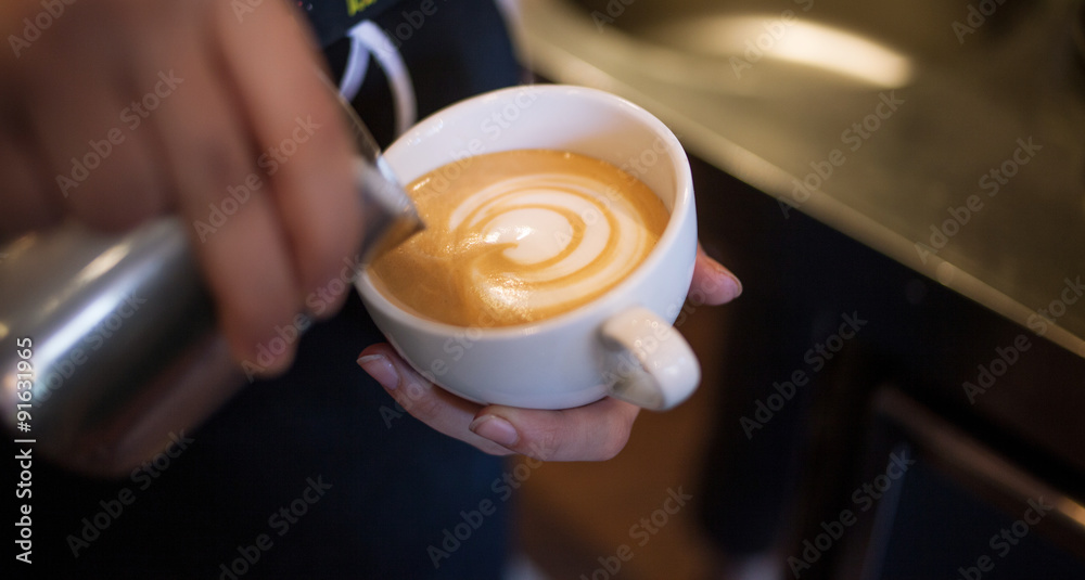 Barista makes latte art, focus in milk and coffee, vintage color Barista makes latte art, focus in milk and coffee, vintage color