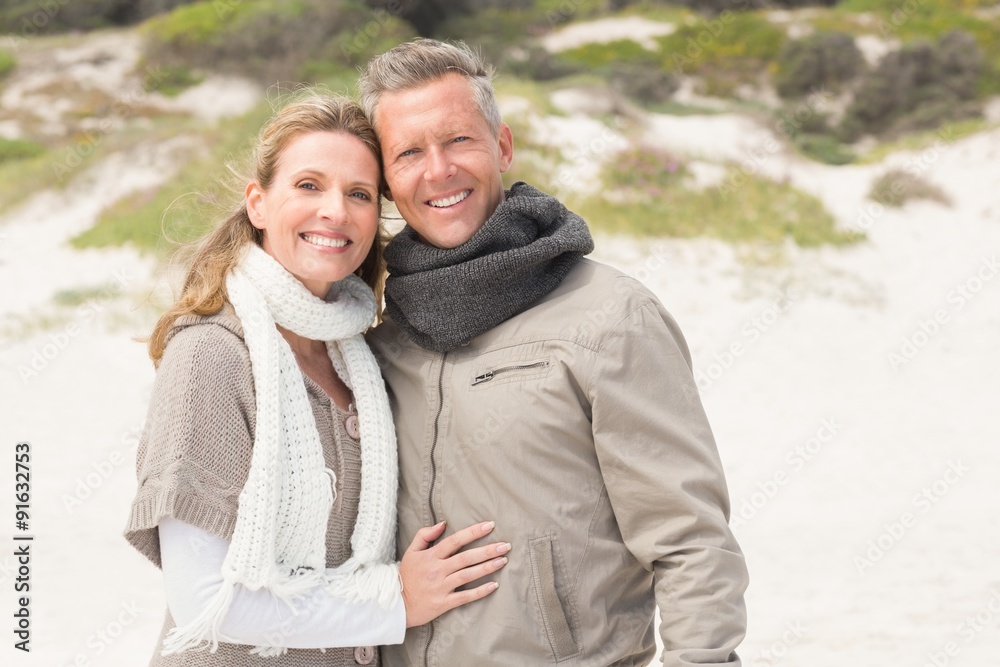 Happy couple embracing by the shore Happy couple embracing by the shore