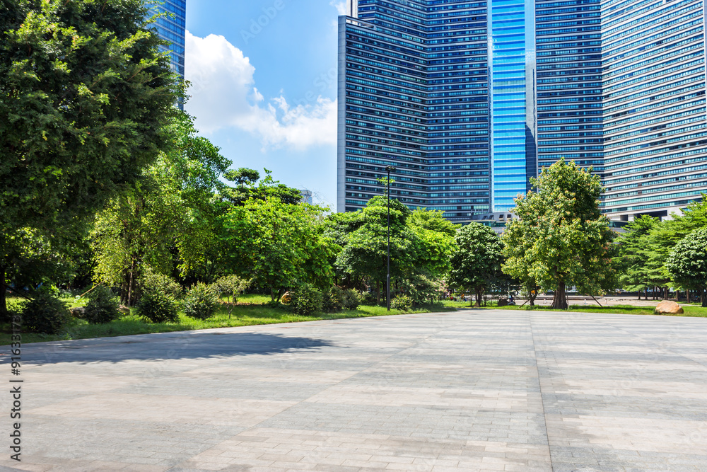 modern square and skyscrapers under blue sky