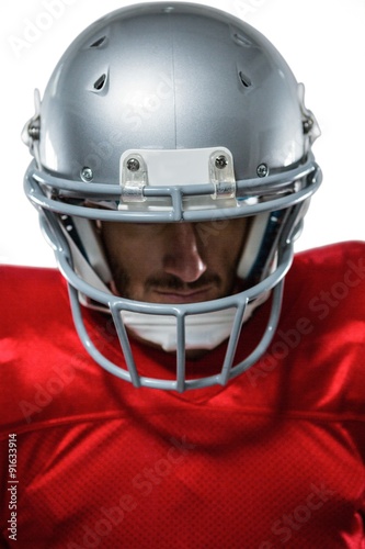 American football player in red jersey looking down