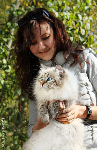 Siberian nevsky masqarade cat and young woman photo