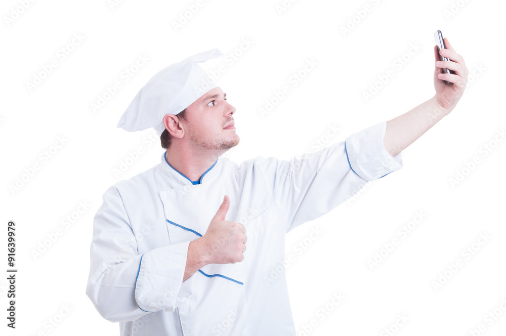 Chef or cook taking selfie with phone camera showing like Chef or cook taking selfie with phone camera showing like
