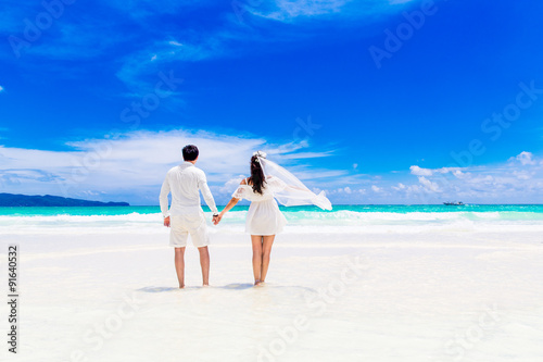 Happy groom and bride on the sandy tropical beach. Wedding and h © frolova_elena