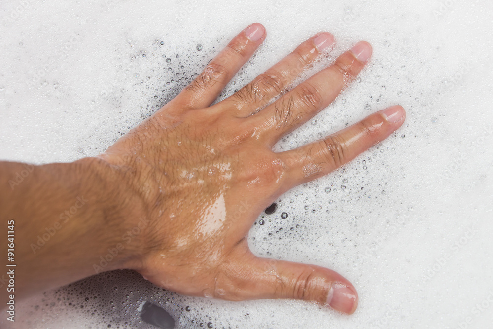 Fototapeta premium Hand washing clothes with soapy water