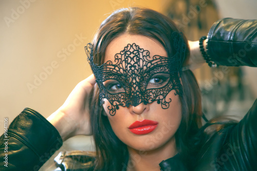 Attractive women with black lace mask.
Shallow depth of field. Selective focus.
