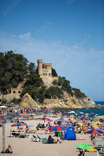 People and sun umbrellas on the beach