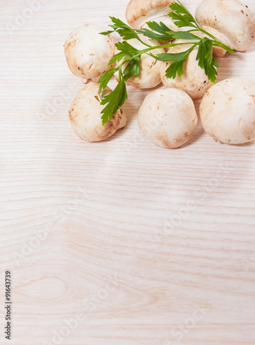 Food background of fresh mushrooms at the wooden board with copy space