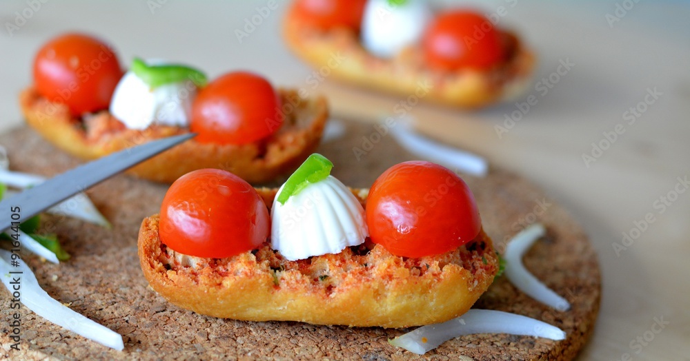 Italian Bruschetta With Mozzarella And Tomato On A Wooden Table
