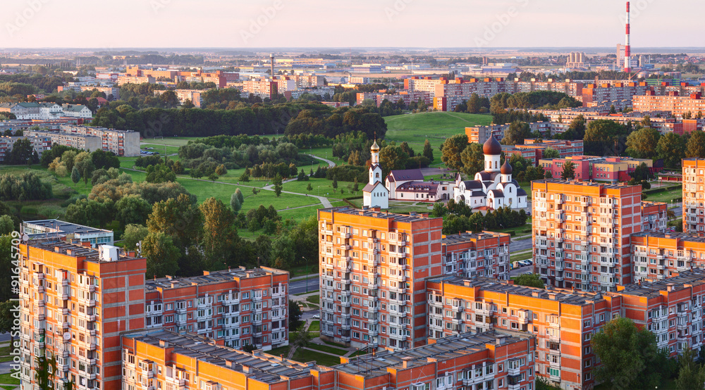 Aerial view of residential (sleeping) district and orthodox church in the sunset time. Klaipeda city, Lithuania.