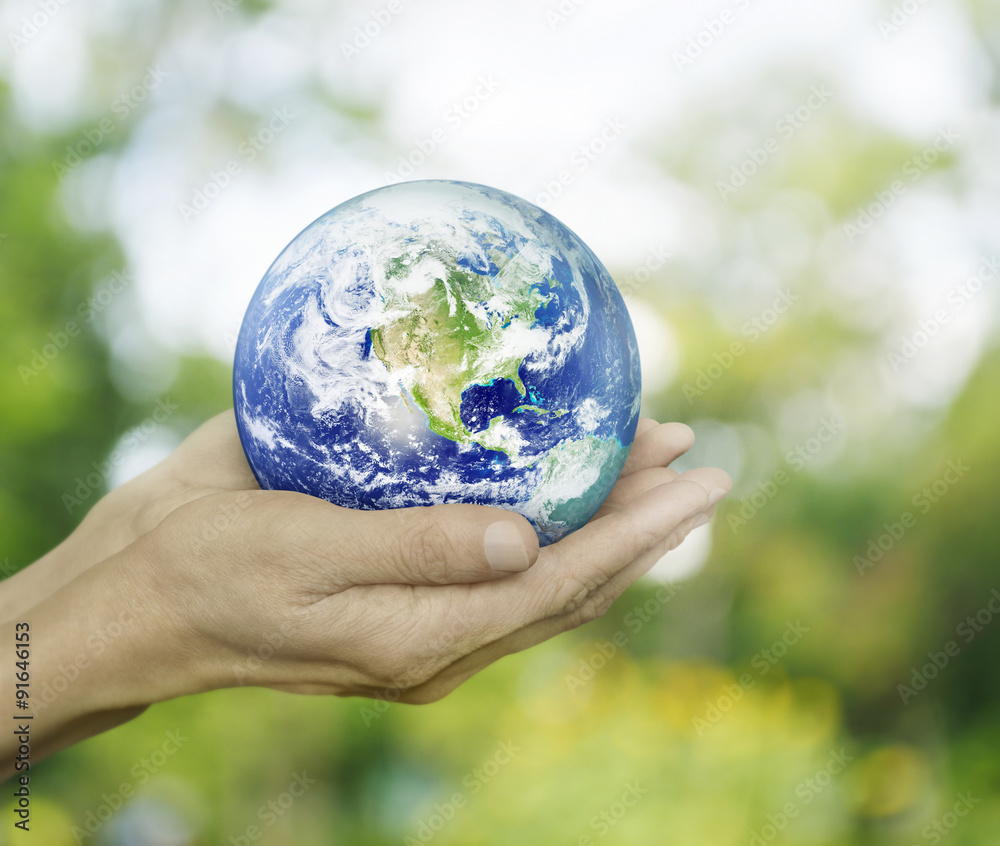 Earth in hands on green bokeh background, Elements of this image Earth in hands on green bokeh background, Elements of this image