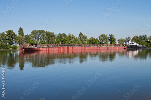 laden barge, floating on a small river