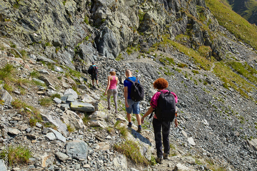 Tourists hiking on mountain trail