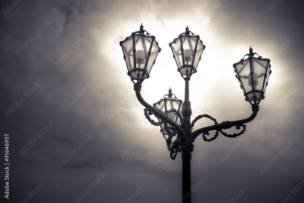 Streetlight of nineteenth century in the middle of a square with