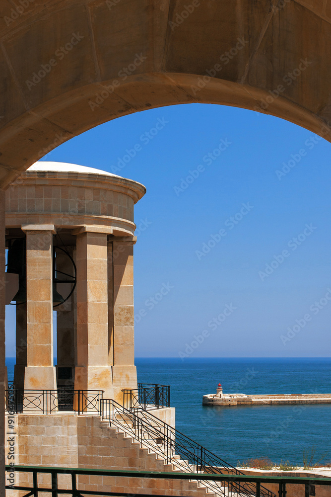 Sea view with beacon and rotunda in the arch