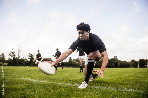 Vászonkép Rugby players training on pitch
