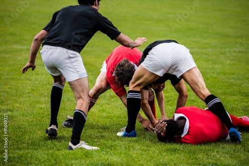 Fotografía Rugby players tackling during game
