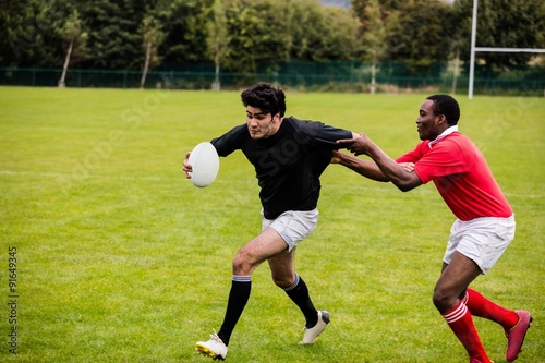 Rugby players tackling during game © WavebreakMediaMicro