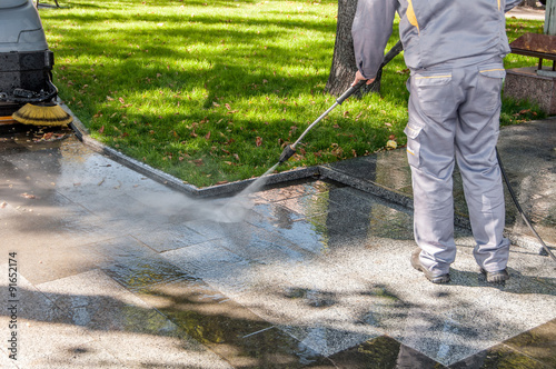 cleaning dirty streets with high pressure cleaner