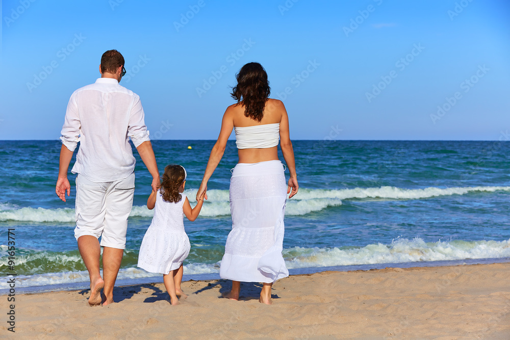 Happy family on the beach sand walking rear Happy family on the beach sand walking rear