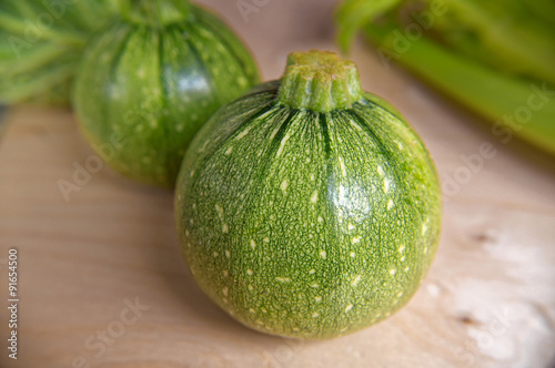 Ripe young round green zucchini . closeup
