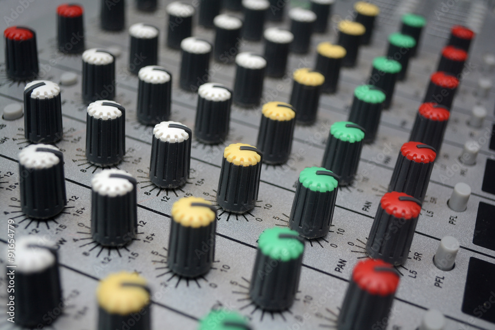 Detail of a music mixer desk with various knobs or slides. shallow depth of field Detail of a music mixer desk with various knobs or slides. shallow depth of field