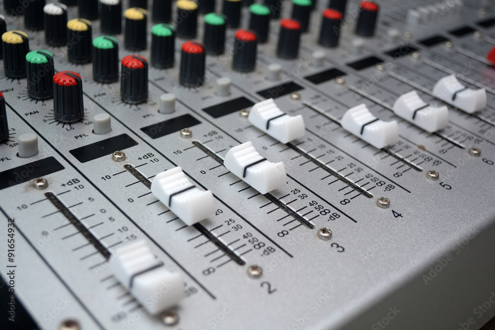Detail of a music mixer desk with various knobs or slides. shallow depth of field Detail of a music mixer desk with various knobs or slides. shallow depth of field