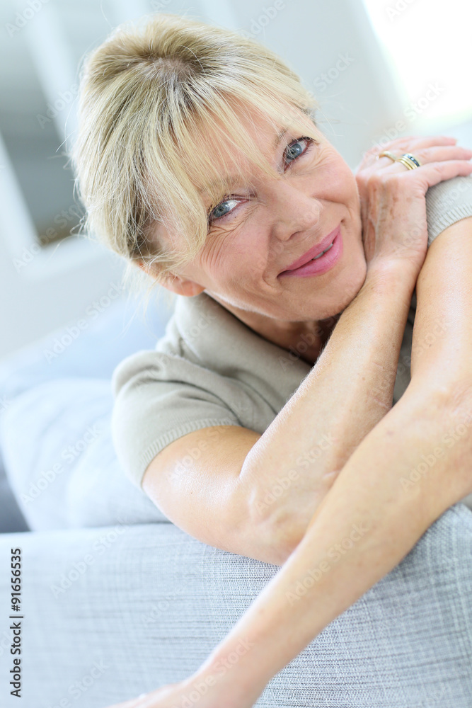 Portrait of senior woman relaxing in couch Portrait of senior woman relaxing in couch