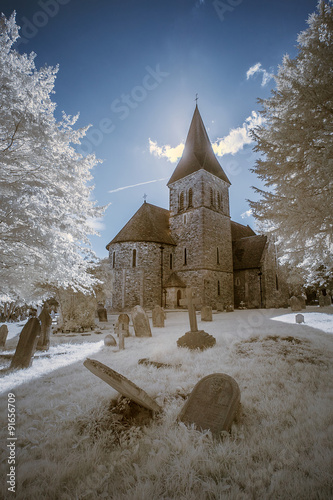 Infrared landscape of old church in churchyard in English countr photo