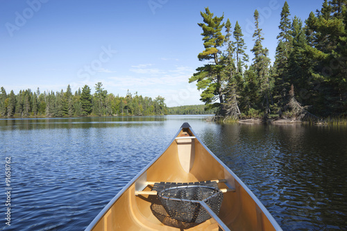 Slika na platnu Canoe with fishing net on northern Minnesota lake