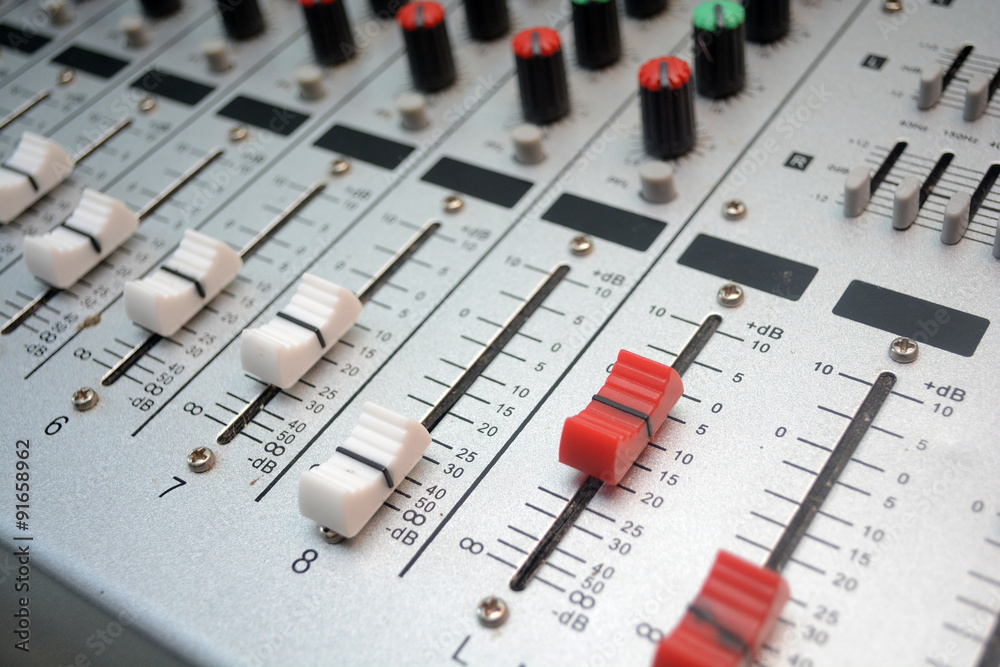 Detail of a music mixer desk with various knobs or slides. shallow depth of field.. Detail of a music mixer desk with various knobs or slides. shallow depth of field..