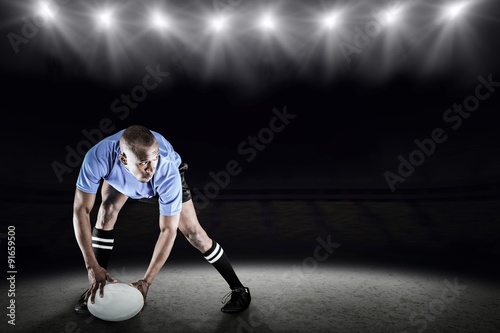 Composite image of rugby player holding ball while playing
