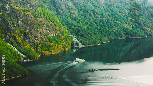 The ship floating in the water in narrowest fjord in Norway - Na