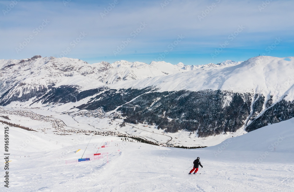 Skier on the slope of  Ski resort Livigno. Italy