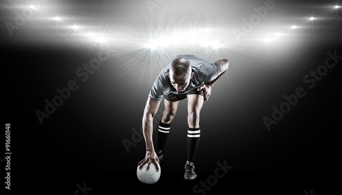 Composite image of rugby player taking position © vectorfusionart