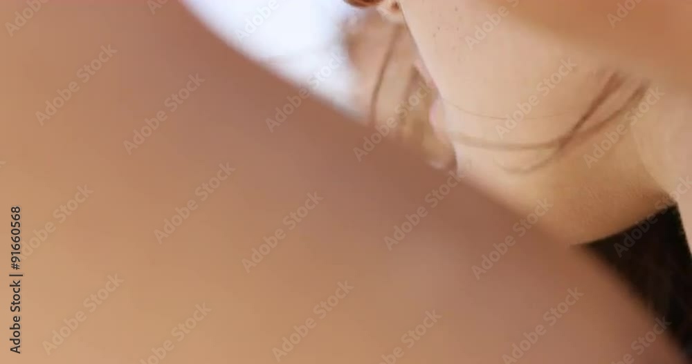 Close up portrait of beautiful young woman tying bikini on beach