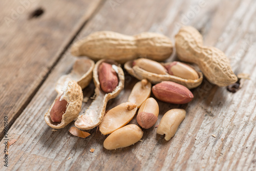 Peeled Peanut on wood background.