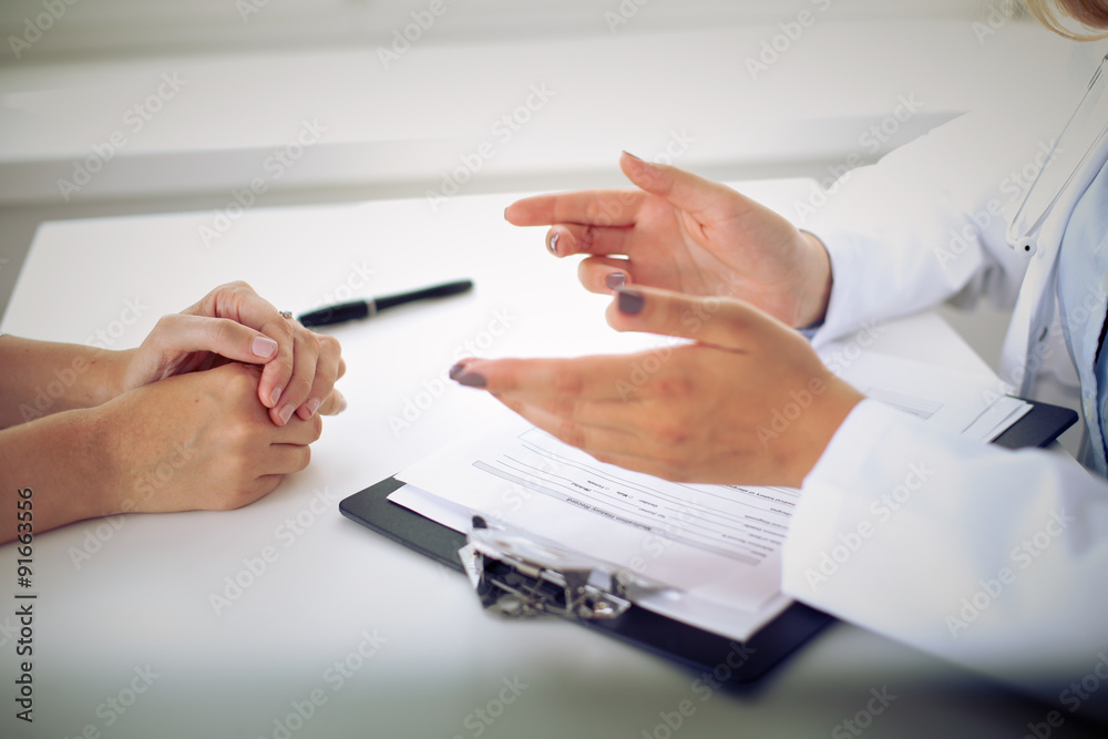 Fototapeta premium Doctor and patient are discussing something, just hands at the table