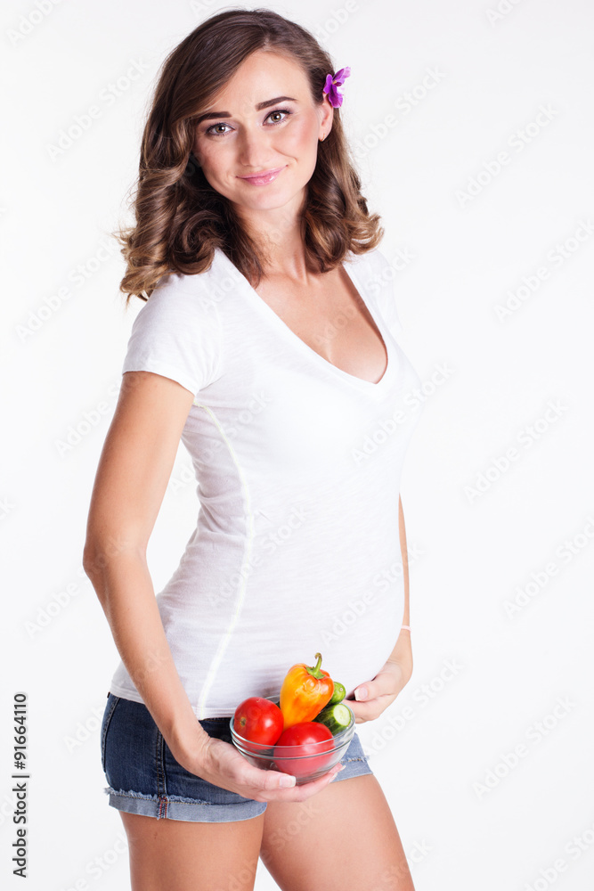 Pregnant happy woman with a plate of vegetables Pregnant happy woman with a plate of vegetables