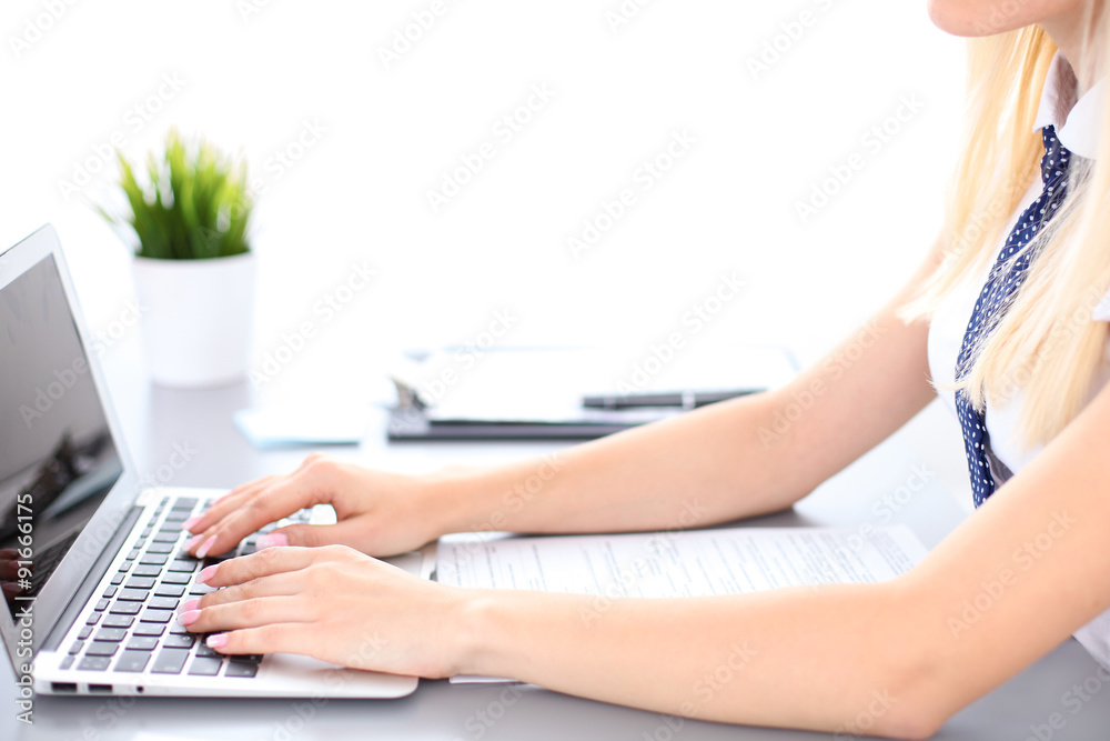 Fototapeta premium Close up of business woman hands typing on laptop computer, blue tie with polka dots